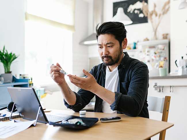 亚洲男子在家检查血糖