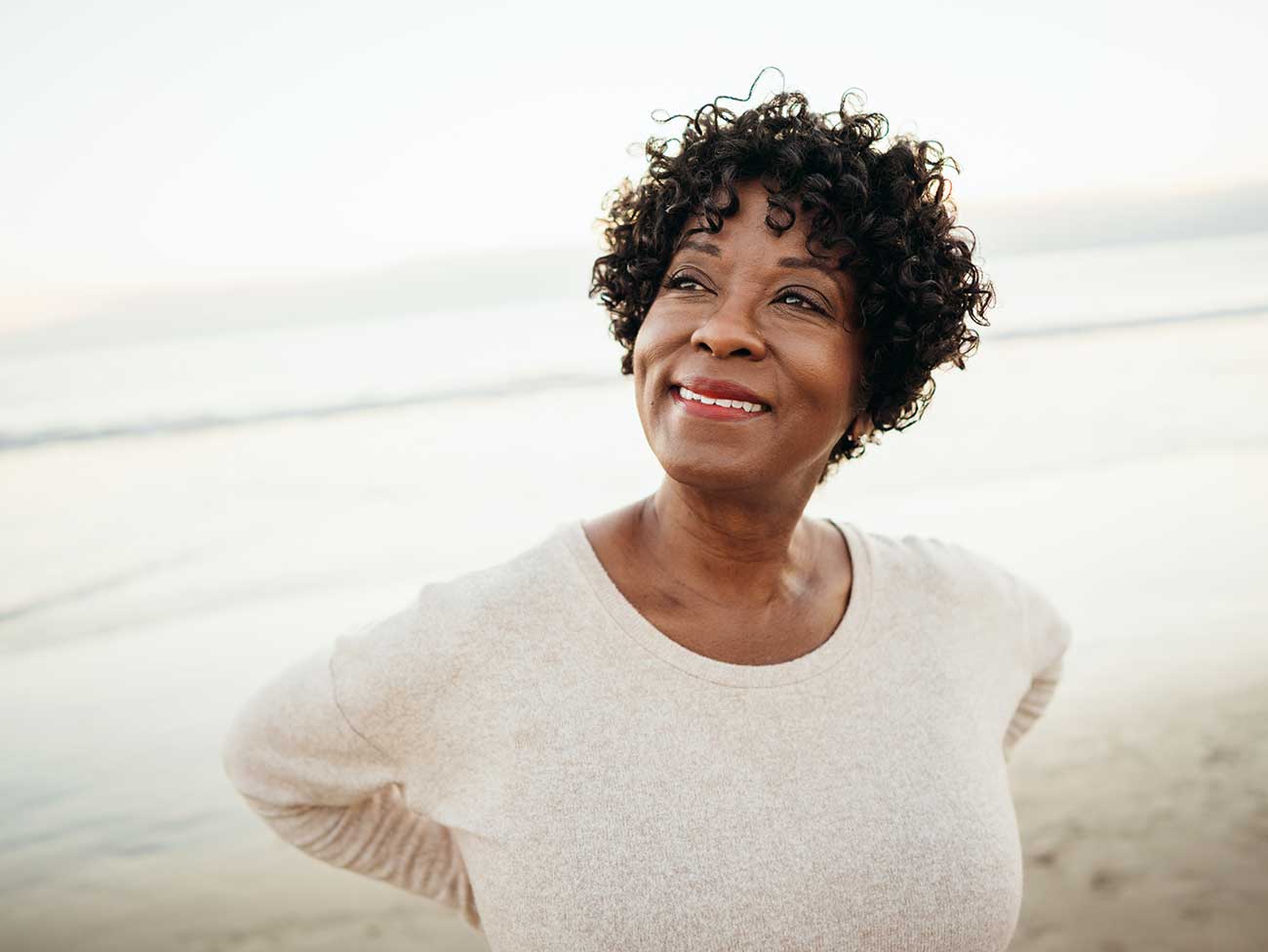 海滩上的一名充满希望的非洲裔美国妇女。