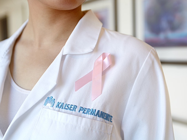 pink ribbon pinned on to the uniform of a Kaiser Permanente physician