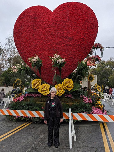 林恩站在前面的吉安KP玫瑰游行花车上的红色的心