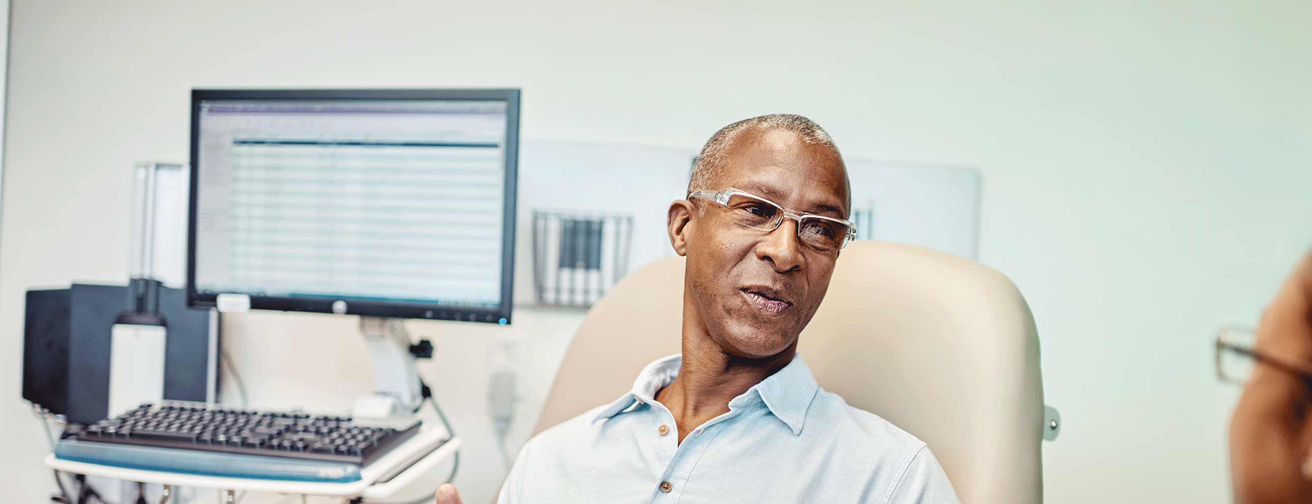 Male patient in an exam room