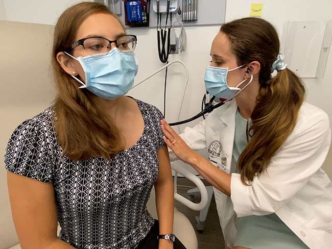 doctor examining patient